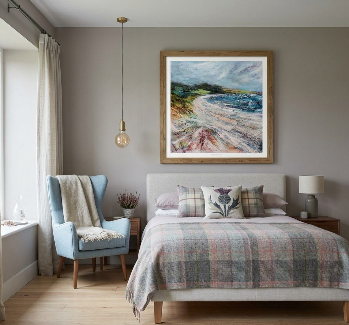 Coastal landscape framed print above a bed in a cosy bedroom