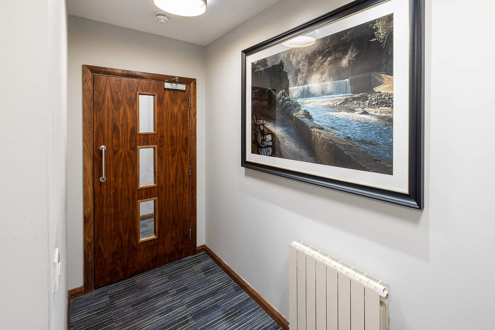 Framed Print In Hotel Corridor beside a door