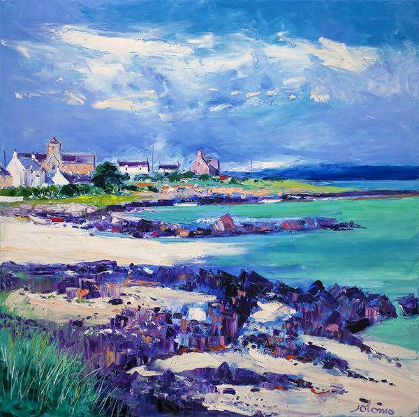 Summer Light at St Ronan's Bay Iona: a colorful painting of white coastal houses by the shore, vibrant blue sky and sea, rocky beach, green grass patches, and clouds overhead—capturing a lively yet serene seaside scene.