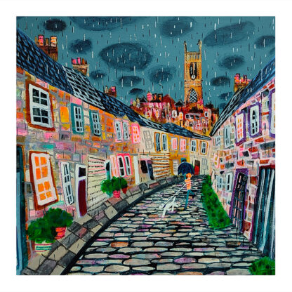 A colorful painting of a quaint cobblestone street with houses under a rainy sky and a church tower in the background. By Nikki Monaghan