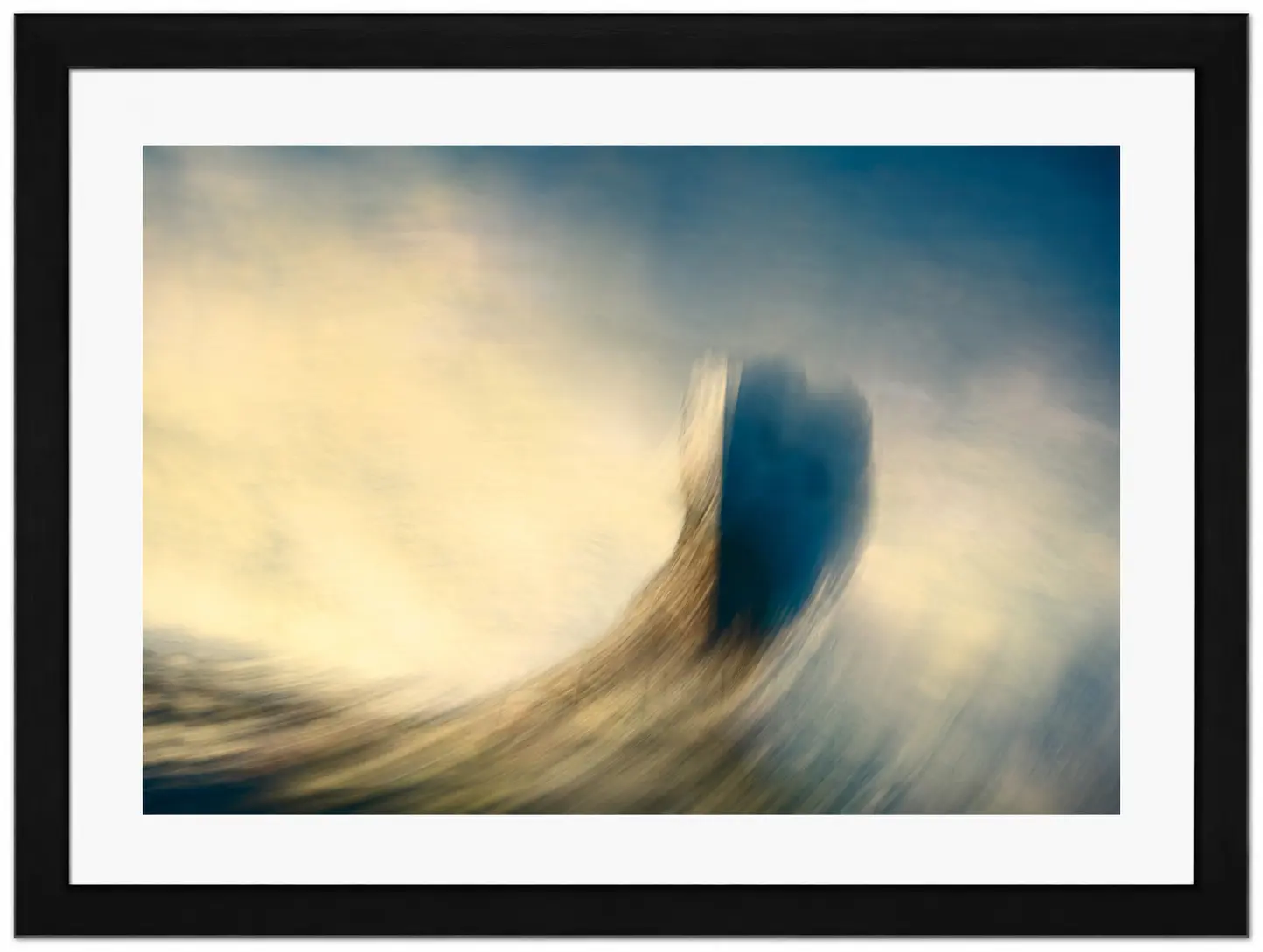 Abstract image with soft, swirling colours in blue, yellow, and beige tones, featuring a dark central shape. Dreamy and blurred, this piece evokes movement and light—an ideal addition to any Noel Fenech Framed Prints collection.