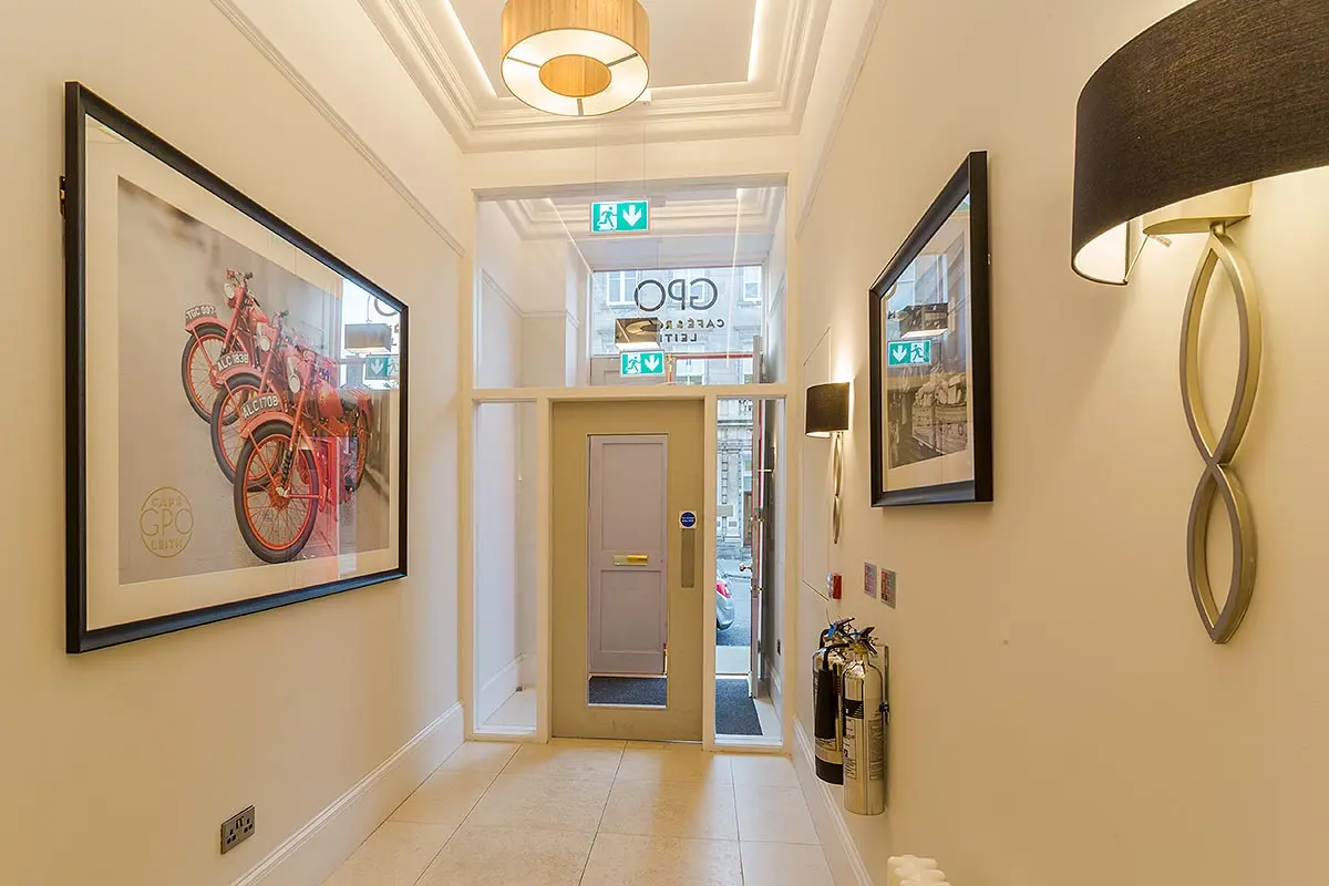 Entrance hall to office space showing framed prints & entrance door.