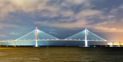 Illuminated suspension bridge in Charleston, SC at night