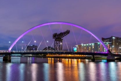 Night lights and the Clyde Arc Bridge at Glasgow City in Scotland over river.