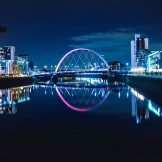 Night view of the Clyde Arc or Squinty Bridge from the East and river Clyde, Glasgow, Scotland
