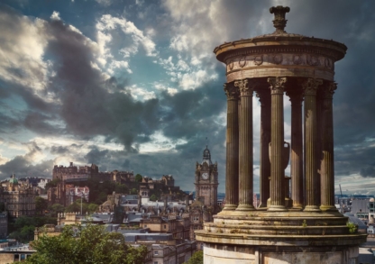 "Framed photograph of Edinburgh's skyline under a cloudy sky, featuring historic landmarks."